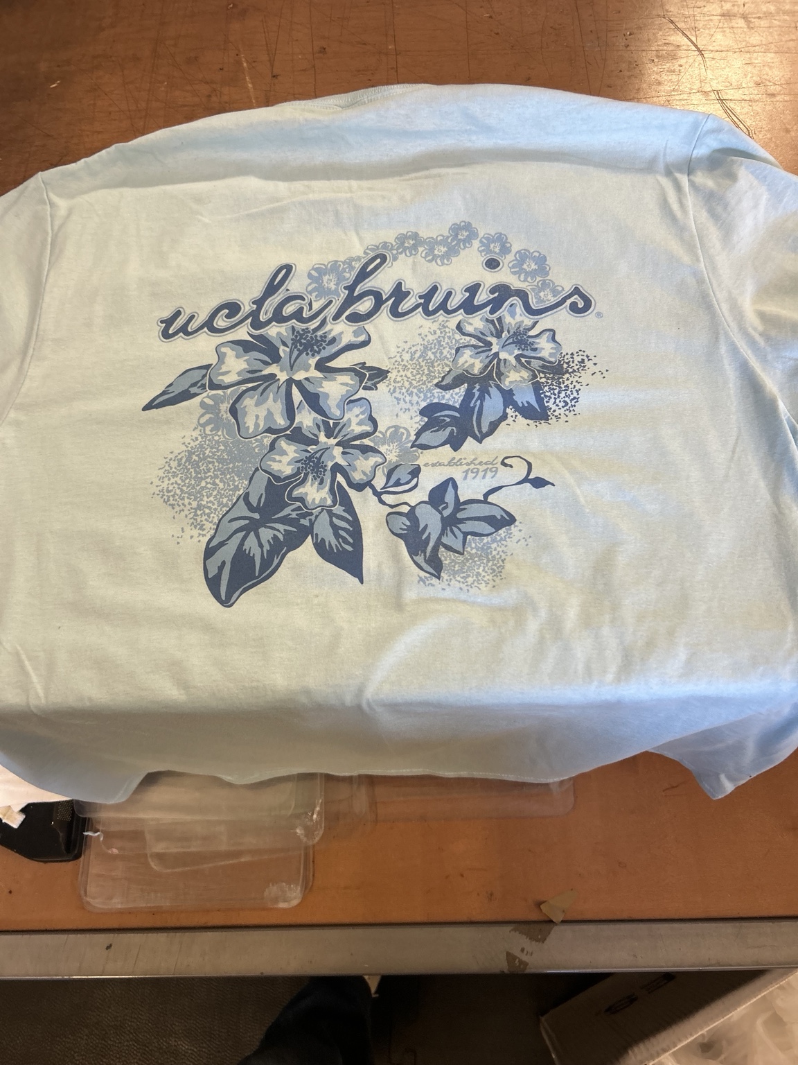 Finished UCLA Bruins floral graphic on a light blue garment